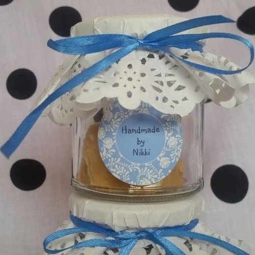Close-up of wedding favour jamjar filled with Homemade tablet (Ben The Hoose in-house recipe), blue ribbon and white lace top