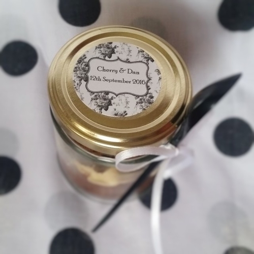Personalised wedding favour lid of cupcake filled jar with spoon. Fancy style